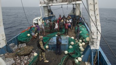 Ghanaian navy and US coast guard officers board a fishing vessel in the Atlantic in 2016 Photograph by Amy M Ressler Alamy