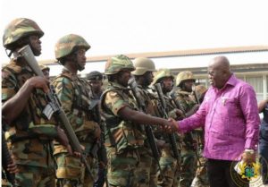 Akufo-Addo interacting with some military men while inspecting a guard of honour