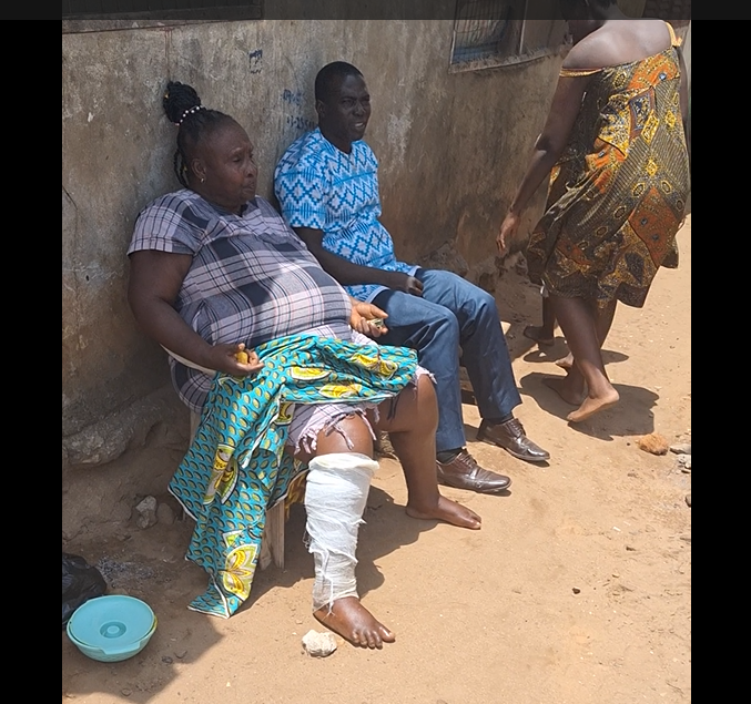 Afua Poma (Maame Turtle, left) seen seated in front of her house in Nyanyano during her arrest. Image credit: Gideon Sarpong, 2024.